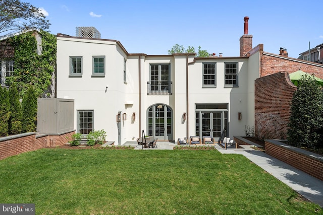 1524 33rd St NW, Washington, DC 20007 - rear view of property with stucco siding, a patio area, a yard, a chimney, and a balcony
