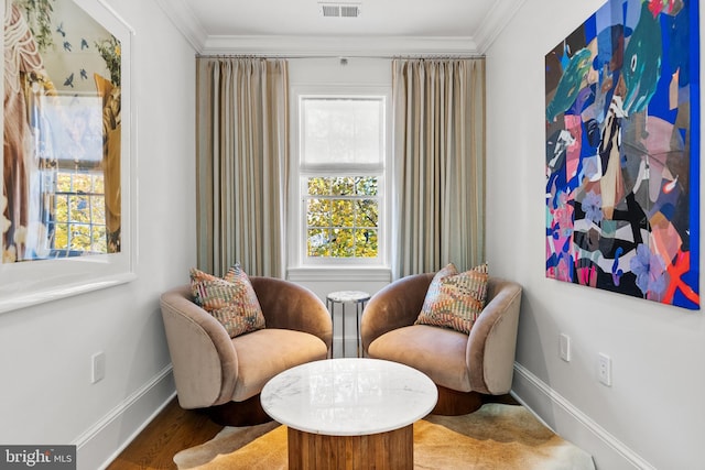 sitting room featuring hardwood / wood-style floors and ornamental molding