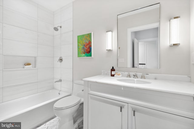 full bathroom with vanity, tiled shower / bath combo, and toilet