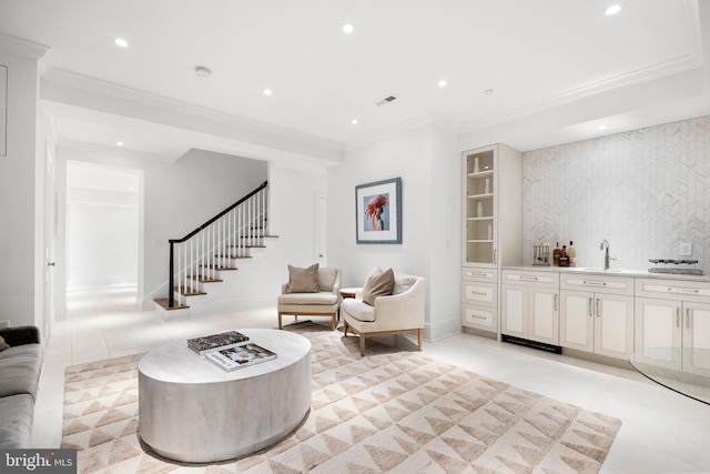 living room with light tile patterned flooring, indoor wet bar, and crown molding