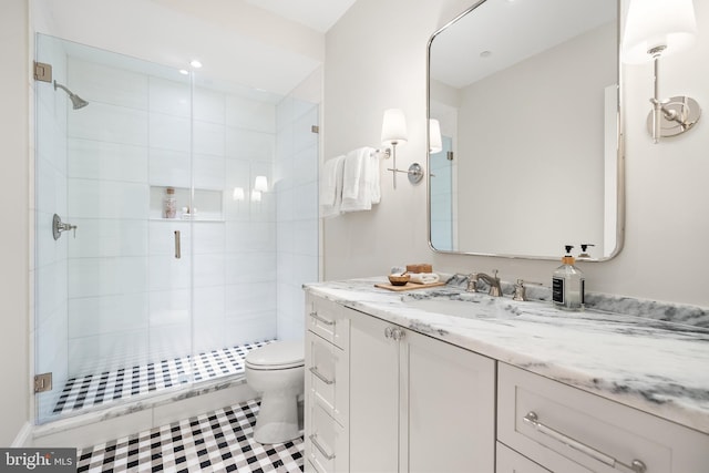 bathroom featuring vanity, toilet, and an enclosed shower