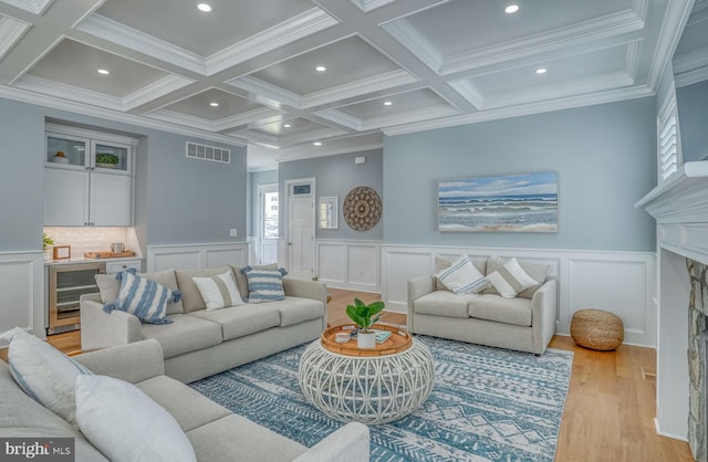 living room with crown molding, light hardwood / wood-style floors, and coffered ceiling