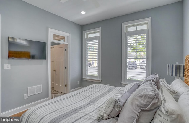 bedroom with hardwood / wood-style flooring and ceiling fan