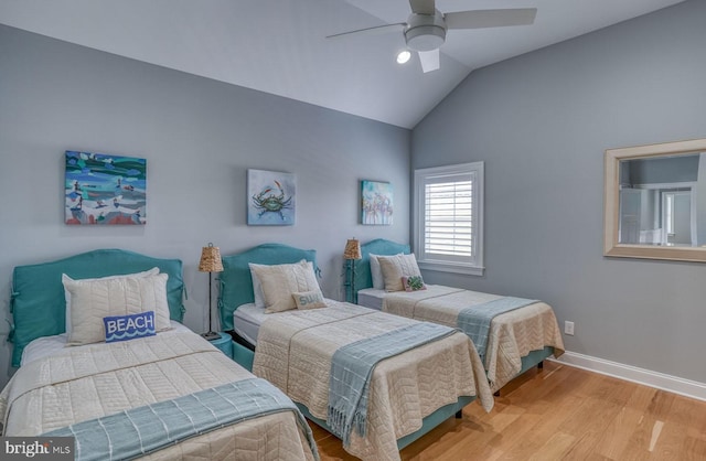 bedroom featuring ceiling fan, wood-type flooring, and lofted ceiling