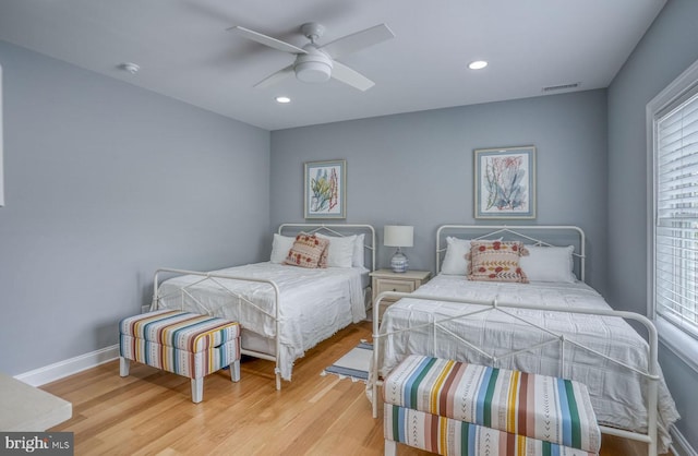 bedroom with ceiling fan and light hardwood / wood-style flooring