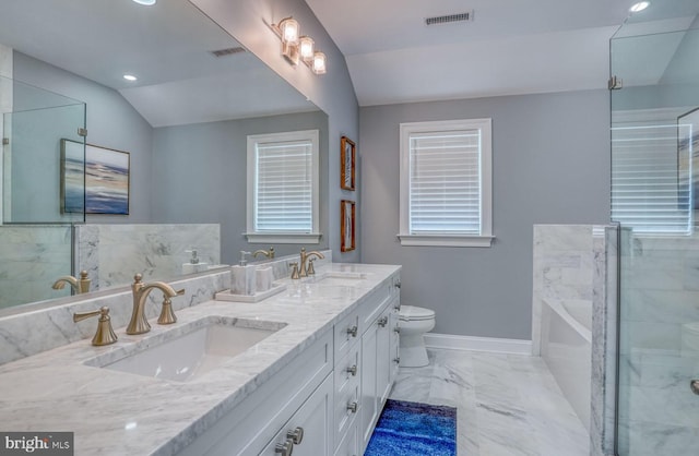 bathroom featuring a bathing tub, vanity, toilet, and vaulted ceiling