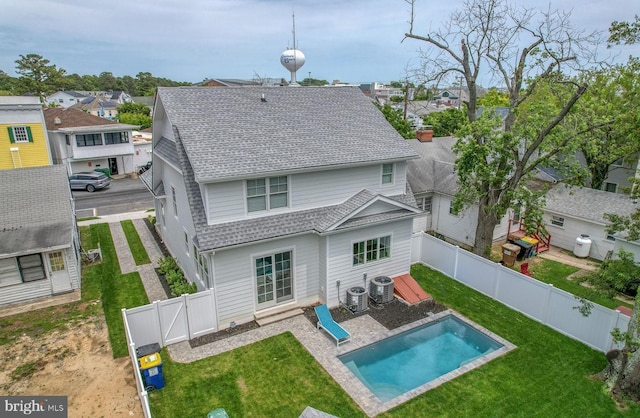 203 Bayard Ave, Rehoboth Beach, DE 19971 - back of property featuring roof with shingles, central AC, a patio area, a gate, and a residential view