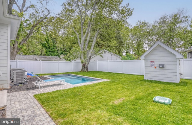 view of yard with a patio, a fenced in pool, and central AC unit