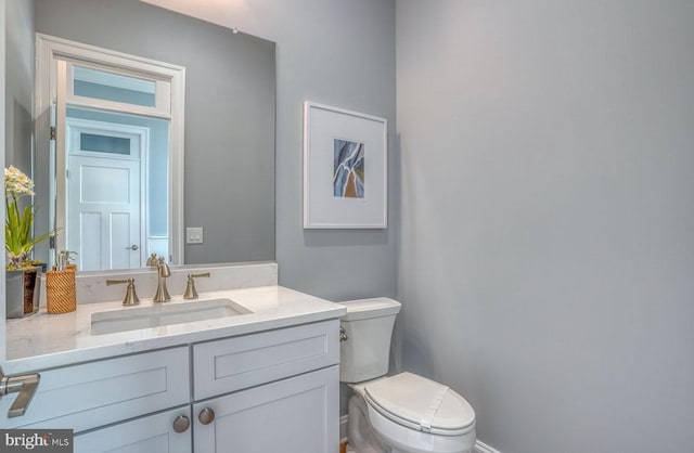 bathroom featuring vanity and toilet