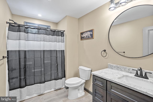 bathroom featuring vanity, toilet, a shower with curtain, and wood-type flooring