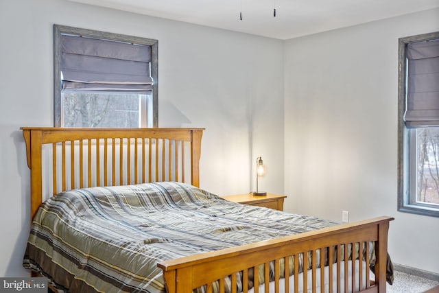 carpeted bedroom featuring multiple windows