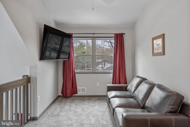 sitting room featuring light carpet