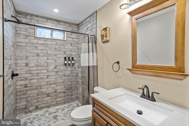 bathroom with walk in shower, vanity, and toilet