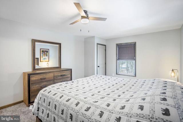 bedroom featuring ceiling fan, a closet, and light colored carpet