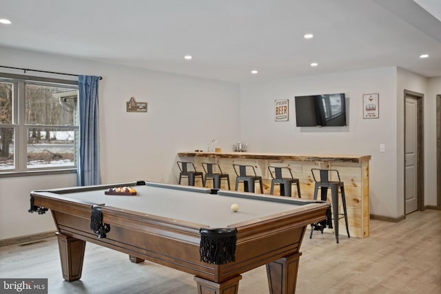 recreation room featuring bar area, light hardwood / wood-style floors, and billiards