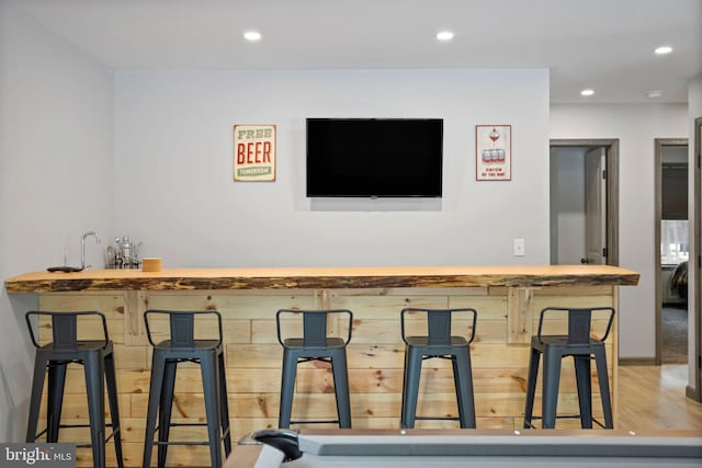 bar with light wood-type flooring