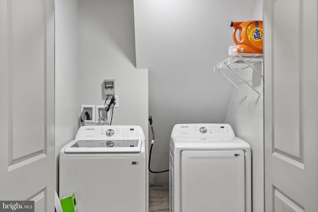 washroom featuring washer and clothes dryer and hardwood / wood-style flooring