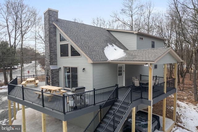 snow covered house with a deck