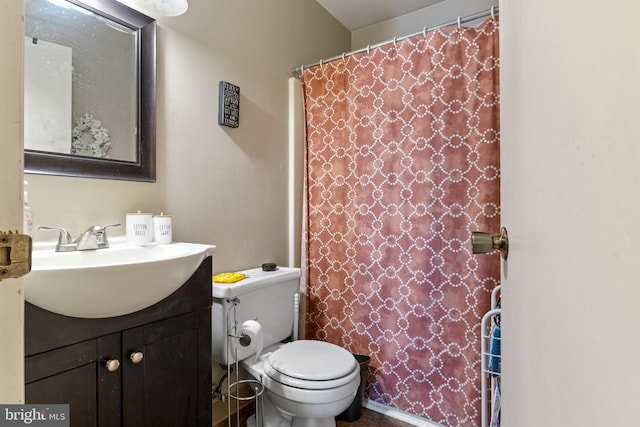 bathroom with vanity, a shower with shower curtain, and toilet