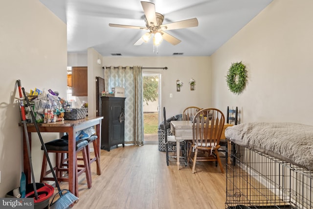 dining room with light wood-type flooring and ceiling fan