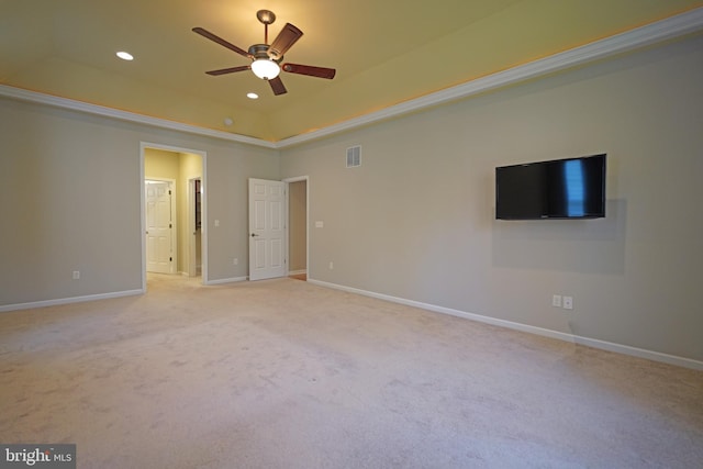 unfurnished bedroom with a raised ceiling, ceiling fan, and light colored carpet