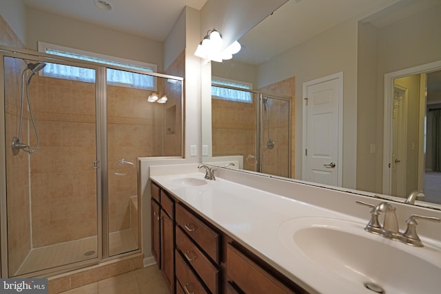 bathroom featuring tile patterned flooring, vanity, and a shower with door