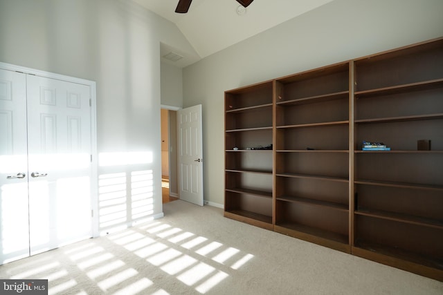 unfurnished bedroom featuring carpet, vaulted ceiling, and ceiling fan