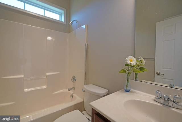 full bathroom featuring bathing tub / shower combination, vanity, and toilet