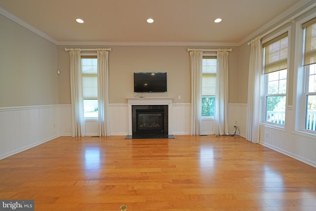 unfurnished living room with light wood-type flooring and a wealth of natural light