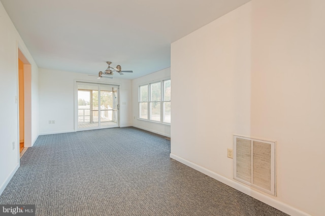 spare room featuring ceiling fan and carpet floors