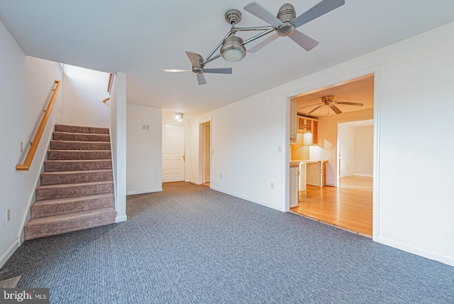 unfurnished living room with ceiling fan and wood-type flooring