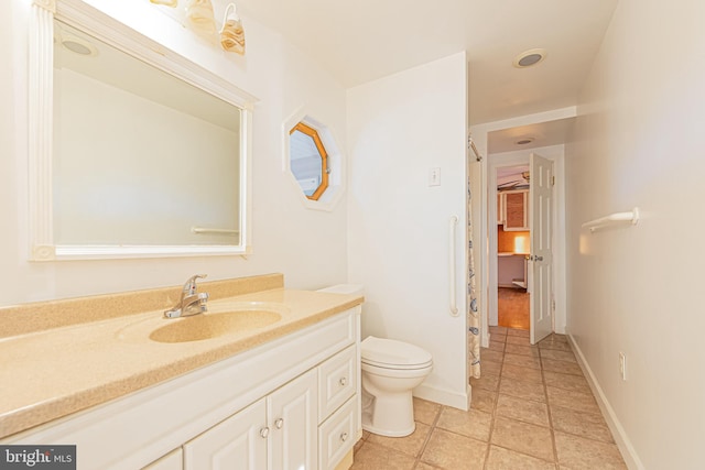 bathroom with tile patterned floors, vanity, and toilet