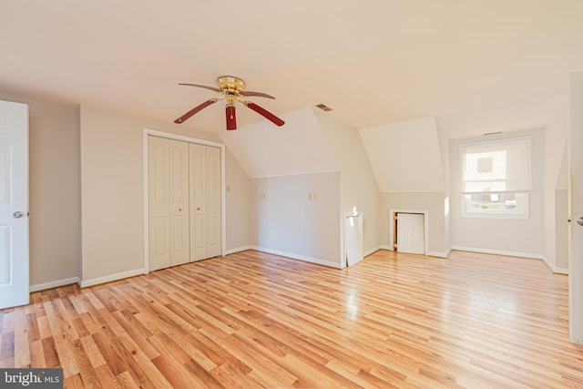 bonus room featuring ceiling fan, vaulted ceiling, and light wood-type flooring