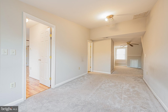 carpeted spare room with ceiling fan