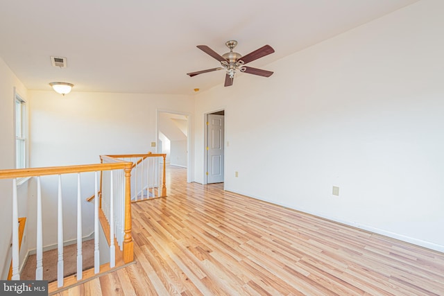 unfurnished room with light wood-type flooring and ceiling fan