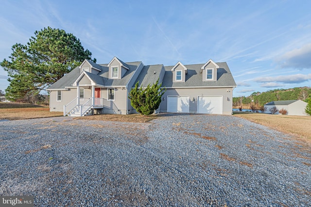 cape cod-style house featuring a garage