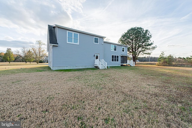 rear view of property with a lawn