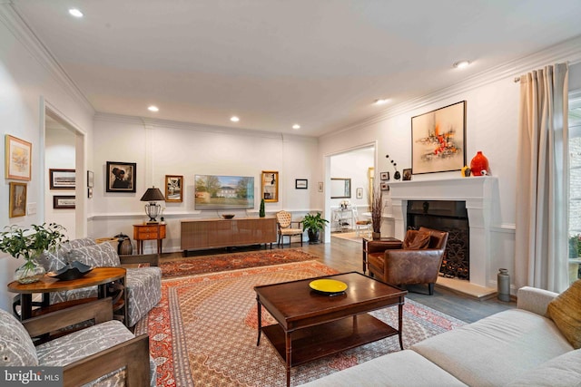 living room featuring wood-type flooring and ornamental molding