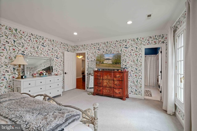 carpeted bedroom with ensuite bath, ornamental molding, and multiple windows