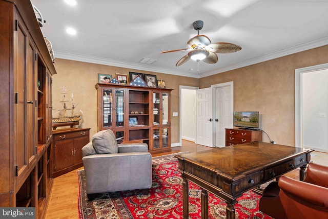 office space featuring light wood-type flooring, ceiling fan, and ornamental molding