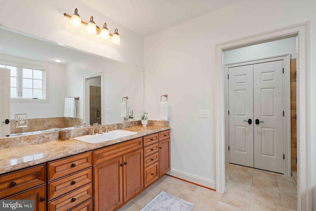 bathroom featuring tile patterned floors, vanity, and a shower with door