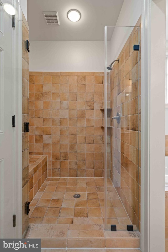 bathroom with a shower with shower door