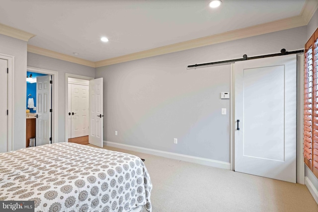 bedroom featuring carpet flooring, a barn door, and crown molding