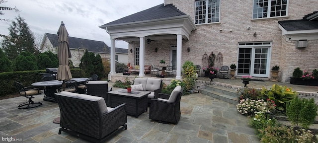 view of patio with ceiling fan and an outdoor hangout area