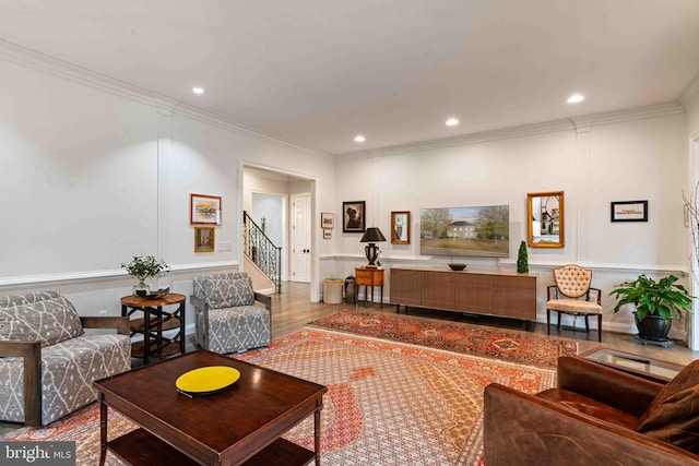 living room with crown molding and hardwood / wood-style flooring