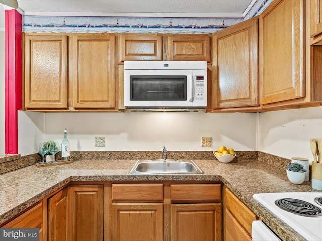 kitchen with a textured ceiling and sink