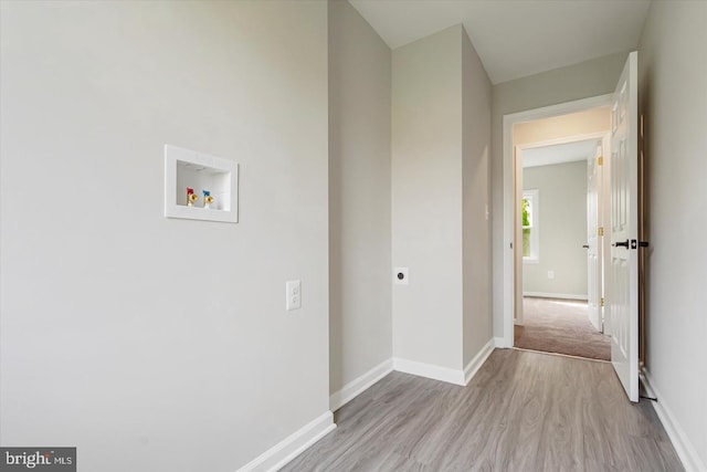 corridor with light hardwood / wood-style floors