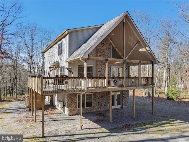 rear view of property with french doors and a deck