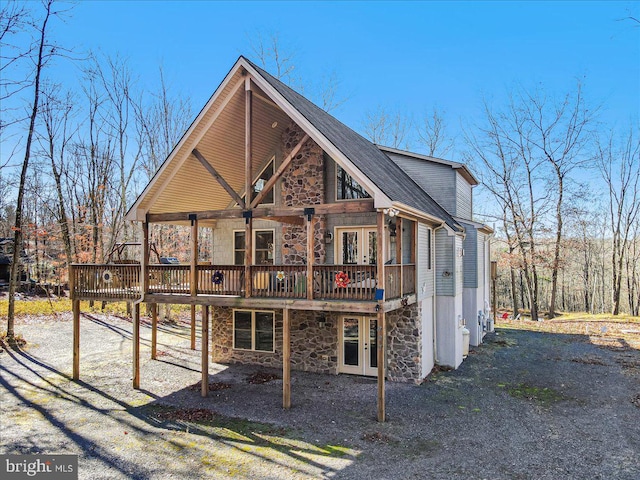 view of front of home with a deck and french doors