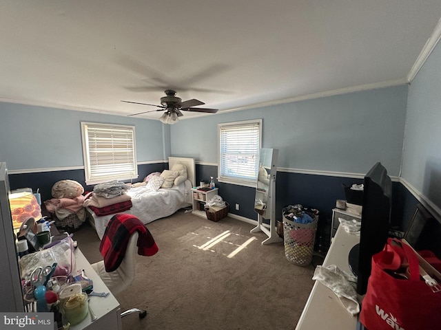 carpeted bedroom with ornamental molding and ceiling fan